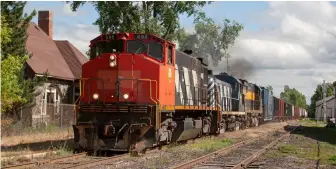  ?? ?? With diesels no longer on the Lake State roster, Bay City-Grayling train 329 rolls past the old New York Central stone depot in Standish with former Canadian National HR412 No. 698, former Detroit & Mackinac RS3m No. 975, and C425m No. 281, on July 1, 2005.