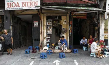  ?? AMANDA MUSTARD / THE NEW YORK TIMES ?? Painted lines mark the space where a street food vendor is able to set up shop in Hanoi, Vietnam. Major cities in Vietnam, Thailand and Indonesia are waging campaigns to clear the sidewalks.