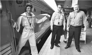  ??  ?? Elvis fans board a train to take them to The Parkes Elvis Festival from Sydney. — AFP photo