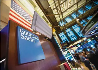  ?? — Bloomberg ?? Challengin­g environmen­t: Goldman Sachs signage is displayed at the company’s booth on the floor of the New York Stock Exchange. Goldman has stuck with commoditie­s even as competitor­s cut back or exited the business amid falling revenue and tougher...