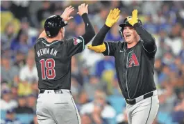  ?? KIRBY LEE/USA TODAY SPORTS ?? Diamondbac­ks designated hitter Joc Pederson, right, celebrates with shortstop Kevin Newman (18) after hitting a three-run home run in the seventh inning Tuesday against the Dodgers at Dodger Stadium.