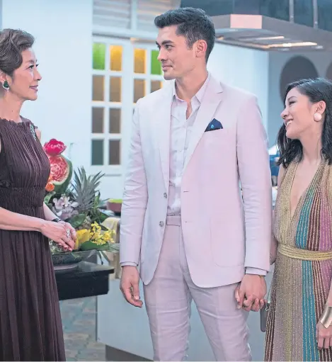  ??  ?? Michelle Yeoh as Eleanor, Henry Golding as Nick and Constance Wu as Rachel in Crazy Rich Asians.