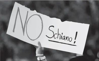  ?? Associated Press ?? Tennessee fans protest: A Tennessee fan holds a sign reading "No Schiano!" during a gathering of Tennessee fans reacting to the possibilit­y of hiring Ohio State defensive coordinato­r Greg Schiano for its head coaching vacancy Sunday in Knoxville, Tenn.