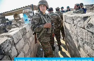  ?? —AFP ?? An Armenian soldier stands at the frontline as troops hold positions yesterday during ongoing fighting between Armenia and Azerbaijan.