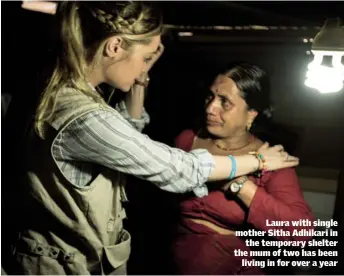  ??  ?? Laura with single mother Sitha Adhikari in the temporary shelter the mum of two has been living in for over a year