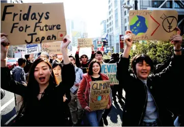  ?? — Reuters photo ?? School students march with signs during the global students strike for action on climate change in Tokyo, Japan.