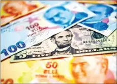 ?? OZAN KOSE/AFP ?? The Turkish lira sank more than three per cent against the dollar after President Recep Tayyip Erdogan fired the head of the central bank, fuelling speculatio­n that borrowing costs will be cut soon.