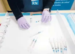  ?? ALLISON ZAUCHA/THE NEW YORK TIMES ?? A nurse prepares doses of the Moderna vaccine in an LA medical office. Vaccine makers are girding for possible new rounds of shots.