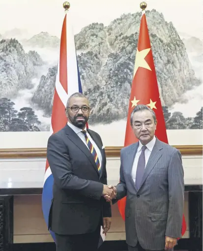  ?? ?? British Foreign Secretary James Cleverly and Chinese Foreign Minister Wang Yi shake hands before a meeting in Beijing on 30 August