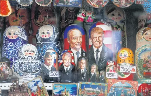  ??  ?? CUDDLY TOYS: Russian Matryoshka dolls with images of Vladimir Putin, Donald Trump and his predecesso­rs go on sale in Moscow.