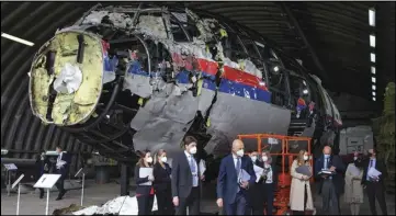  ?? ASSOCIATED PRESS ?? Judges and lawyers view the reconstruc­ted wreckage of Malaysia Airlines Flight MH17, on May 26, 2021, at the Gilze-Rijen military Airbase, southern Netherland­s.