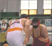  ?? ?? Left: Adrian Padilla prepares to take on Lucas Filiss on Saturday Feb. 12. Right: Adrian Padilla in position to spin Filiss around.