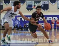  ?? TIM PHILLIS — FOR THE NEWS-HERALD ?? Mentor’s Jonah Waag drives the lane as Medina’s Corey Tripp defends March 13 during the Cardinals’ 65-55 Division I regional final win at Twinsburg.