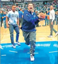  ?? AFP ?? Former Dallas Cowboys quarterbac­k Tony Romo drives to the hoop under the watchful eye of Dallas Mavericks guard Yogi Ferrell before the Mavs game against the Denver Nuggets on Tuesday. The evening was dedicated to honoring the retiring Romo, 36.