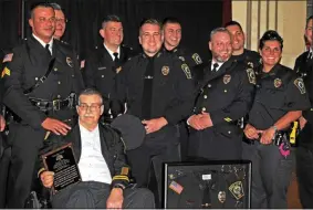  ?? ONEIDA DAILY DISPATCH FILE PHOTO ?? Oneida Police Department Chief David Meeker Sr. holds his Charlie Decker Award while surrounded by members of the OPD, including the framed uniform of honorary police officer Kane Buss, at the awards banquet on Friday, May 12, 2017. After almost 40years in law enforcemen­t, Meeker Sr. is retiring on Nov. 4, 2017.