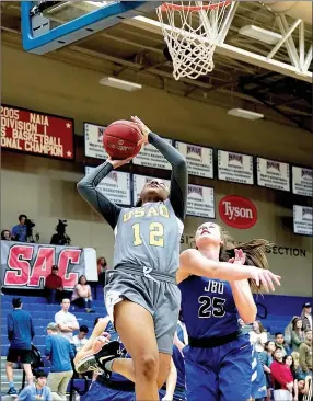  ?? Matthew Christense­n/JBU Sports Informatio­n ?? Science and Arts guard Dierra Ely fights off John Brown’s Preslea Reece for a shot attempt Friday during the semifinals of the Sooner Athletic Conference Tournament at Bill George Arena.