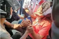  ??  ?? Wounded: Mya Thwe Thwe Khaing is helped on ground