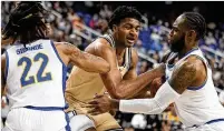  ?? ?? Tech guard Dallan Coleman drives between Pittsburgh guards Nike Sibande and Jamarius Burton during the first half Wednesday. The Jackets rallied but lost 89-81.