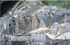  ?? ?? Firefighte­rs work at a damaged building in Serhiivka.