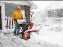  ?? GENE WALSH — DIGITAL FIRST MEDIA ?? Robert Martz clears the snow from his driveway along Wilson Street in Pottstown on Wednesday.
