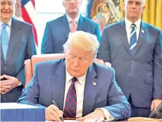  ??  ?? Trump is seen signing the CARES Act. Congress passed the US$2.2 trillion CARES Act in March to bolster the economy but key provisions have expired and an agreement on another measure has proven elusive, with a US$500 billion spending proposal failing to pass the Senate in recent days.