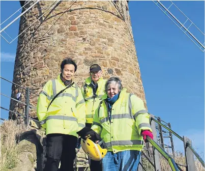 ??  ?? Volunteers Henry Sun, Coastwatch St Monans station manager John Kinsman and Anne Kinsman will be part of the team helping to keep the windmill open.