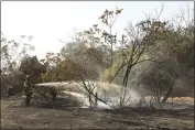  ?? CARIN DORGHALLI — ENTERPRISE-RECORD FILE ?? Left to right, Vashaun Mickens and Jose Nuno of Cal FireButte County put out hotspots from a fire Oct. 15, 2020, near Grand Avenue in Oroville.