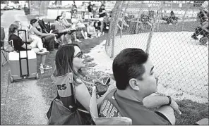  ?? Chicago Tribune/ARMANDO L. SANCHEZ ?? Marilu Arce and her husband, Raul Arce, watch their daughter Alyssa Arce, 17, play softball at Bettenhaus­en Park earlier this month in Tinley Park, Ill. Marilu Arce says working from home two days a week freed up time for her to take her daughters to...