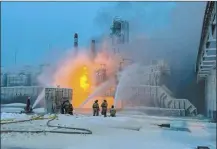  ?? Telegram Channel of Leningrad Region Governor Alexander Drozdenko photo via AP ?? Fire fighters extinguish a blaze at Russia’s second-largest natural gas producer, Novatek in Ust-Luga, 102 miles southwest of St. Petersburg, Russia, on Sunday.