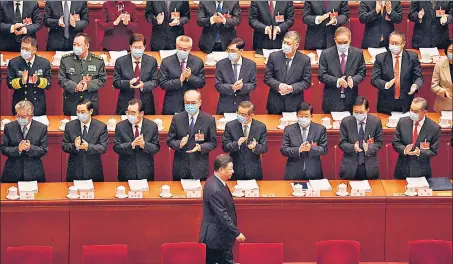  ?? AFP ?? Delegates applaud as China's President Xi Jinping (centre) arrives for the opening ceremony of the National People's Congress at the Great Hall of the People in Beijing.