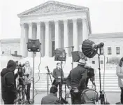  ?? J. SCOTT APPLEWHITE/AP ?? Television news crews stake out the Supreme Court last week following the Politico news report of a draft opinion to overturn Roe v. Wade.