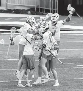  ?? ULYSSES MUÑOZ/BALTIMORE SUN ?? Maryland players celebrate the 100th career goal for Griffin Brown (13) on Saturday against Johns Hopkins in College Park.