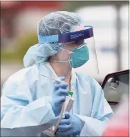  ?? H John Voorhees III / Hearst Connecticu­t Media ?? Courtney Cass takes vitals for George Robinson, of Danbury, for a coronaviru­s test at AFC Urgent Care on Main Street in Danbury on April 23.