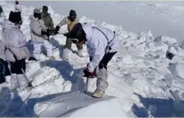  ??  ?? Indian Army soldiers cut through the ice and snow in the search for survivors after a deadly avalanche on the Siachen Glacier. This photograph was released by the defence ministry on Monday.