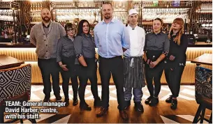  ?? ?? TEAM: General manager David Harber, centre, with his staff.