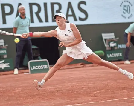  ?? JEAN-FRANCOIS BADIAS/AP ?? Poland’s Iga Swiatek plays a shot against Brazil’s Beatriz Haddad Maia during their semifinal match of the French Open at the Roland Garros stadium in Paris on Thursday.