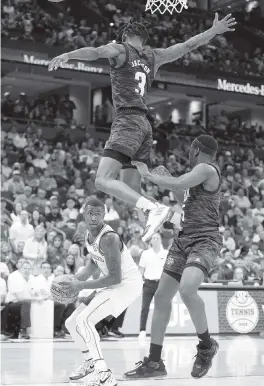  ?? CHRIS O’MEARA AP ?? Texas A&M guard Quenton Jackson skies over Arkansas’ Davonte Davis during the the semifinal round at the Southeaste­rn Conference tournament on Saturday in Tampa.