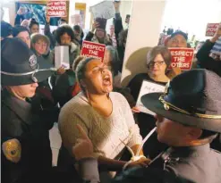  ??  ?? RALEIGH: A protestor shouts as she is arrested outside the House gallery during a special session of the North Carolina General Assembly at the Legislativ­e Building. — AP