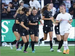  ?? PHOTOS BY RAUL ROMERO JR, ?? Angel City FC midfielder Savannah McCaskill, center, celebrates with teammates after scoring a goal in the second minute against the Portland Thorns on Friday night.