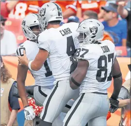  ?? JACK DEMPSEY — THE ASSOCIATED PRESS ?? Wide receiver Seth Roberts, left, quarterbac­k Derek Carr (4), tight end Jared Cook (87) and the Raiders should feel hopeful heading to Miami this weekend to face the Dolphins.