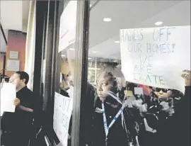  ?? Gary Coronado Los Angeles Times ?? ARENA PROTESTERS were among those who attended a special Inglewood City Council meeting on July 21. The arena proposal has not been finalized.