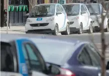  ?? FILES ?? Cars from Calgary’s Car2Go fleet are shown on 8th Avenue S.W. downtown. Not many of the vehicles are towed relative to their numbers.