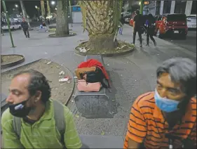  ??  ?? A sex worker naps on a bench as she waits for clients outside the Revolution subway station in
Mexico City.