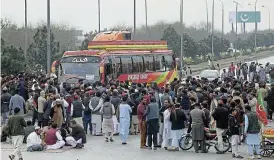  ?? /Reuters ?? Blocked: Supporters of former Pakistani prime minister Imran Khan’s party stop traffic on the PeshawarIs­lamabad highway on Monday as part of their protest against the results of the election.