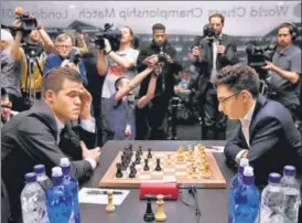  ?? REUTERS ?? Carlsen (left) and Caruana during their World Chess Championsh­ip match in London on Friday.
