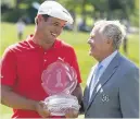  ??  ?? LEGEND DeChambeau gets the trophy from all-time golfing great Jack Nicklaus