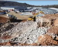  ??  ?? An excavator clears space for an expansion Tuesday at Wilson Combat in Berryville. The firearms-maker is expanding to provide space for additional machinery to help build parts for pistols, rifles, shotguns and accessorie­s. Check out nwaonline. com/201213Dail­y/ and nwadg.com/photos for a photo gallery. (NWA Democrat-Gazette/David Gottschalk)