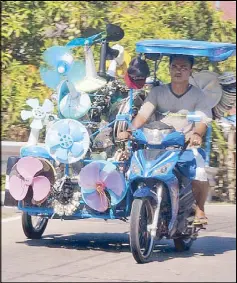  ?? CESAR RAMIREZ ?? A man who repairs electric fans and washing machines drives a tricycle packed with spare parts in Lingayen, Pangasinan early this week.
