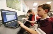  ?? ROGELIO V. SOLIS — THE ASSOCIATED PRESS ?? Third-grade student Miles Stidham uses an East Webster High School laptop to do homework in Maben, Miss.