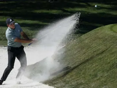  ?? Associated Press ?? First-round leader Sergio Garcia blasts out from the bunker on the ninth hole Friday at TPC Sawgrass. He fell back into a tie for third after shooting an even-par 72 in the second round.